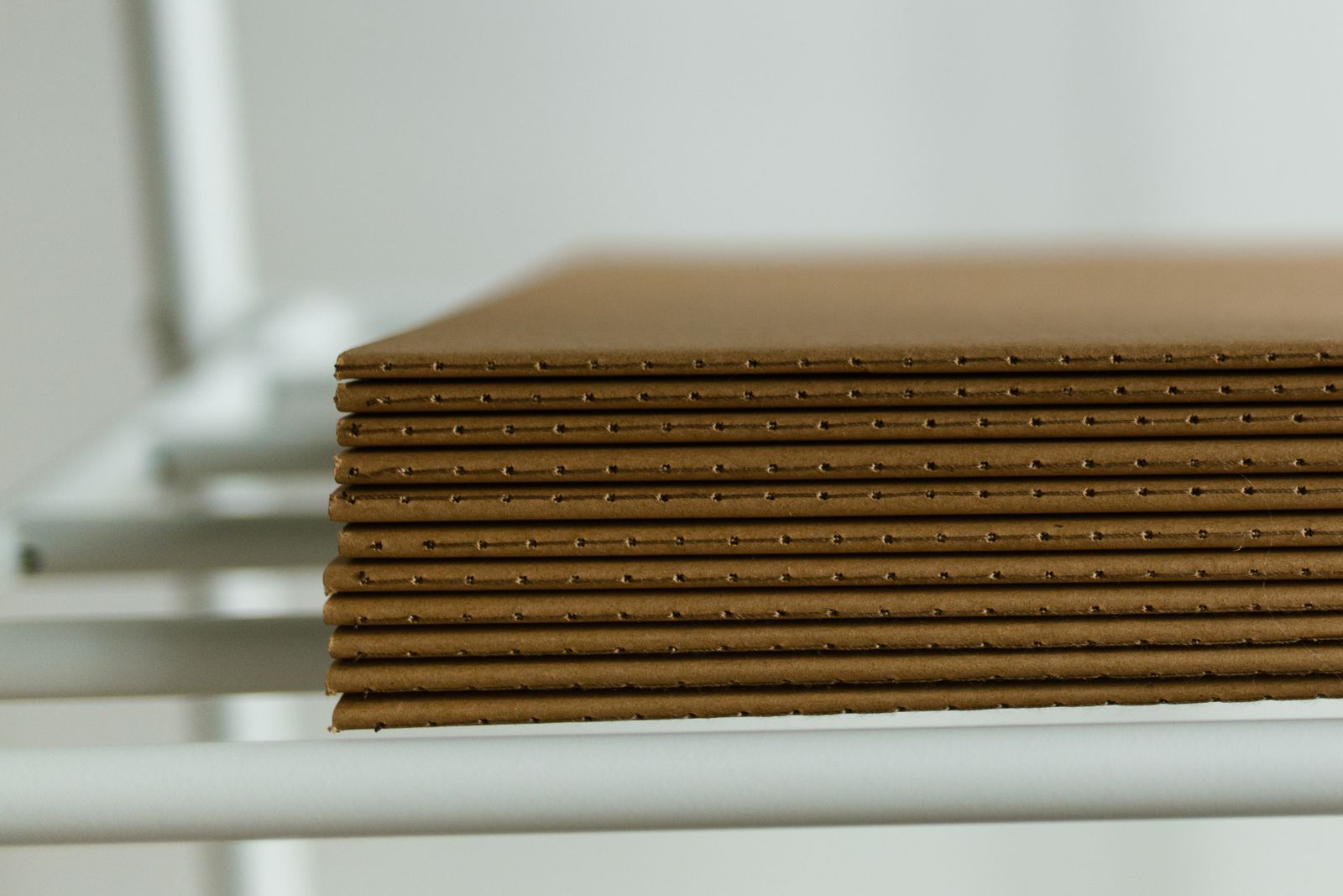 Stacked corrugated cardboard sheets for shipping cartons