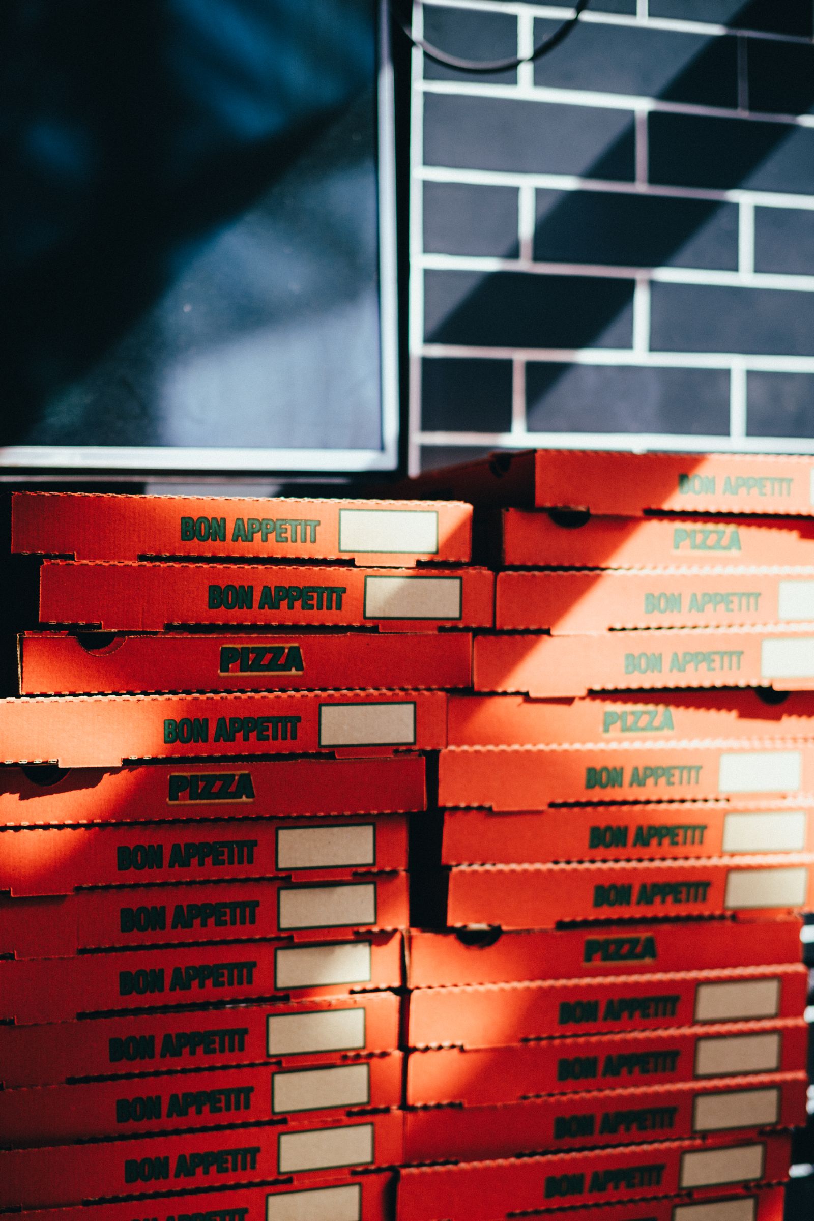 Stack of custom-printed pizza boxes